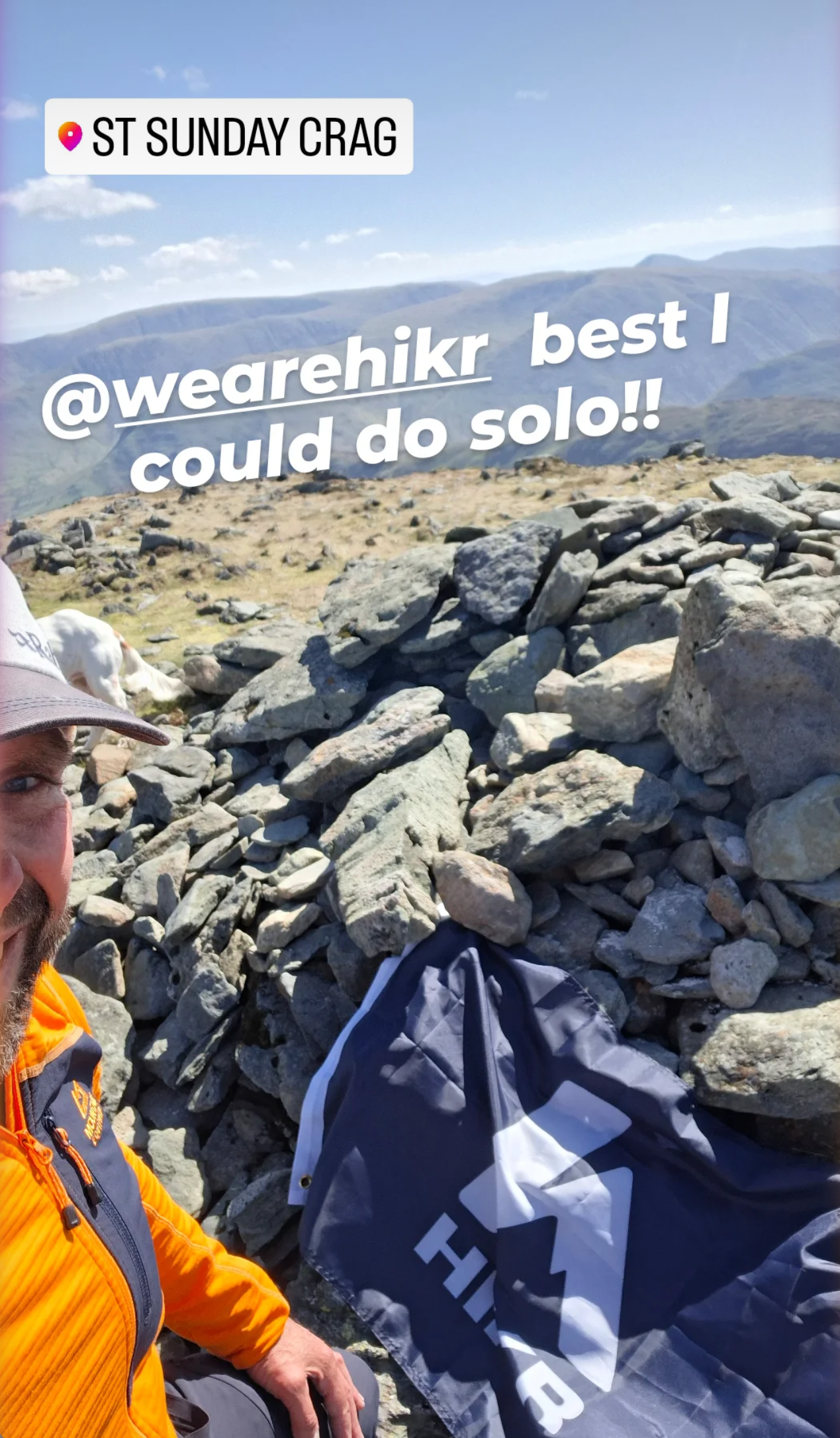 Person sitting on rocks with a backpack, text overlay on a scenic background
